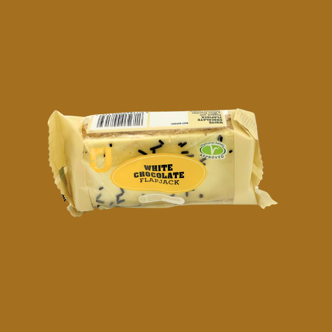 Open flapjack showing white chocolate layer over soft oat bar