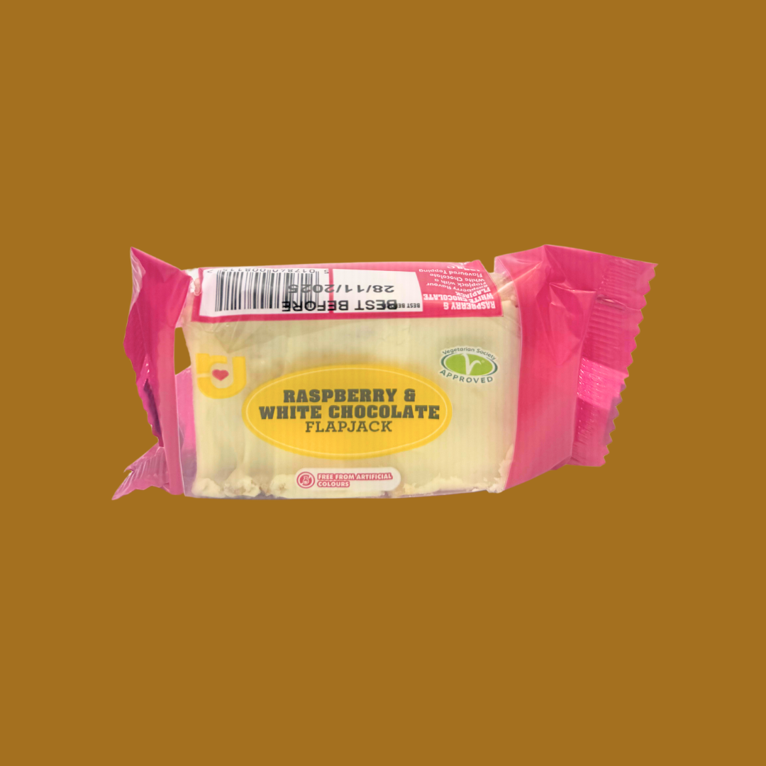 Row of 24 individually wrapped raspberry chocolate flapjacks on a picnic table