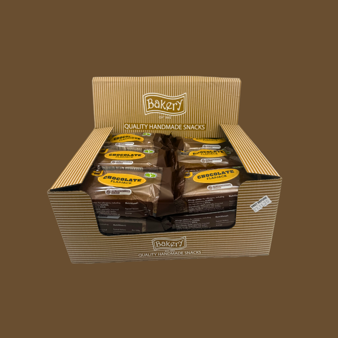 Close-up of a chocolate snack bar beside a glass of milk