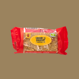 Row of 24 RJ Cherry & Coconut flapjacks neatly arranged on a wooden board
