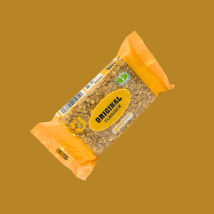 Hand holding an Original oat bar over a picnic blanket
