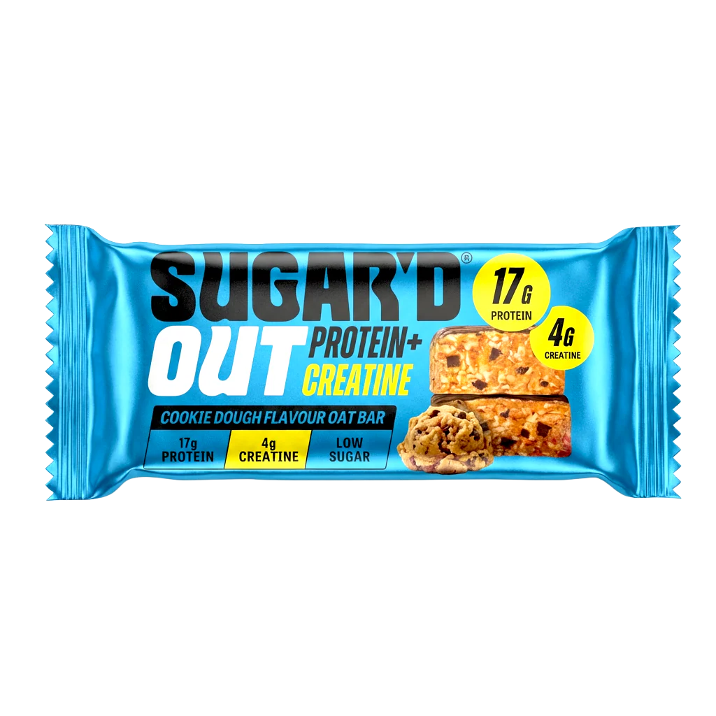 Unwrapped Sugar'D Out Cookie Dough Protein + Creatine Oat Bar (68g) on a white background with visible oat texture and cookie-dough pieces, wrapper from the 12-pack placed beside the bar
