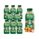 Eight bottles of Starbucks Caramel Hazelnut Flavour Protein Drink, each bottle is 330ml. The packaging is predominantly green with Starbucks branding and the product name prominently displayed.