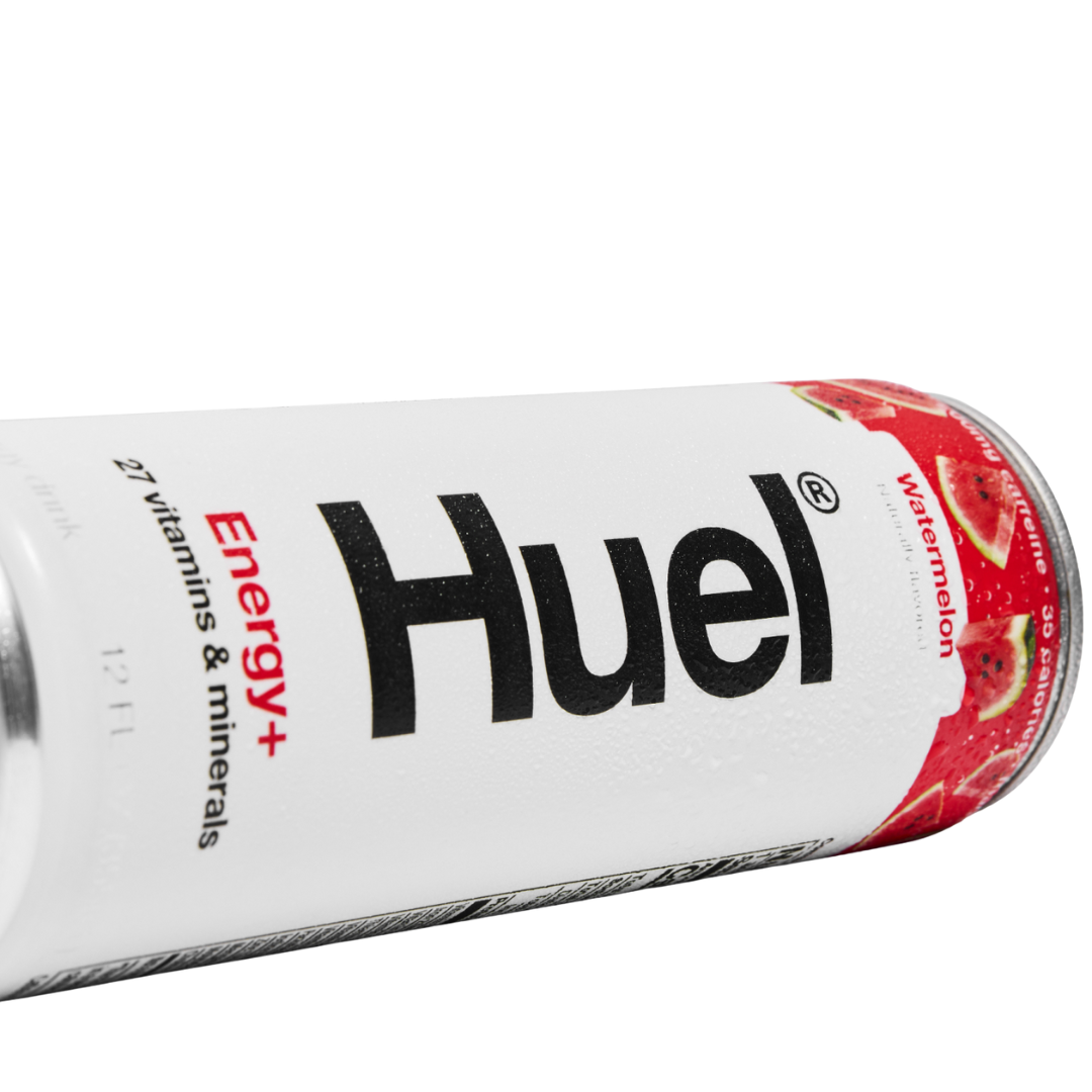 Chilled Huel watermelon energy drink can beside fresh watermelon slices
