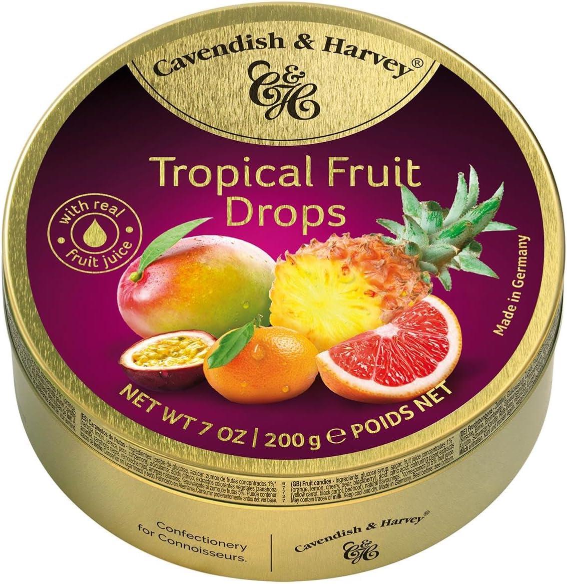 Close-up of assorted Cavendish & Harvey tropical hard candy drops (200g), glossy round sweets in vibrant tropical colors spilled next to the product packaging