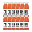 A bottle of Pressuice Pink Grapefruit Juice with fresh grapefruits in the background.