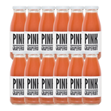 A bottle of Pressuice Pink Grapefruit Juice with fresh grapefruits in the background.