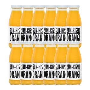 A bottle of Pressuice Sun-Kissed Orange Juice with fresh oranges in the background.