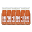 A bottle of Pressuice Pink Smoothie alongside fresh strawberries, raspberries, and bananas.